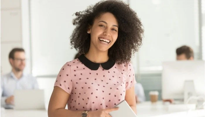 happy-african-businesswoman-holding-digital-tablet-looking-at-camera-picture-